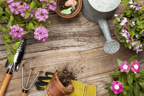 Gardener carrying out safe outdoor maintenance with protective equipment