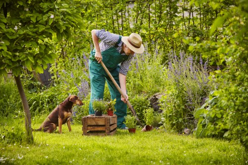 Team member checking tools and site conditions before garden work